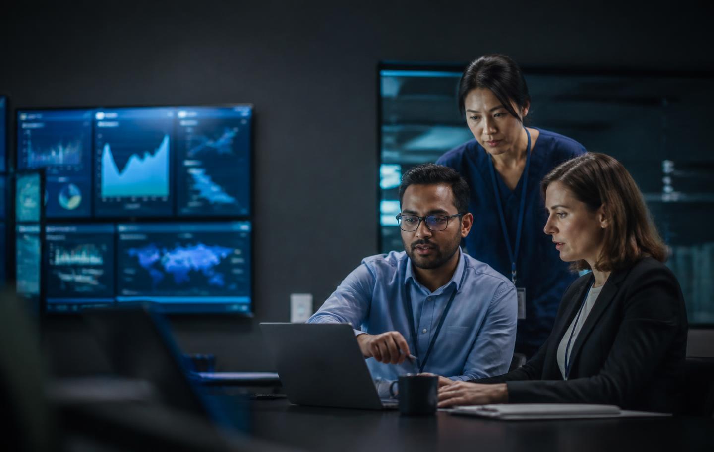 Compliance and cybersecurity team reviewing risk evidence in a secure operations room